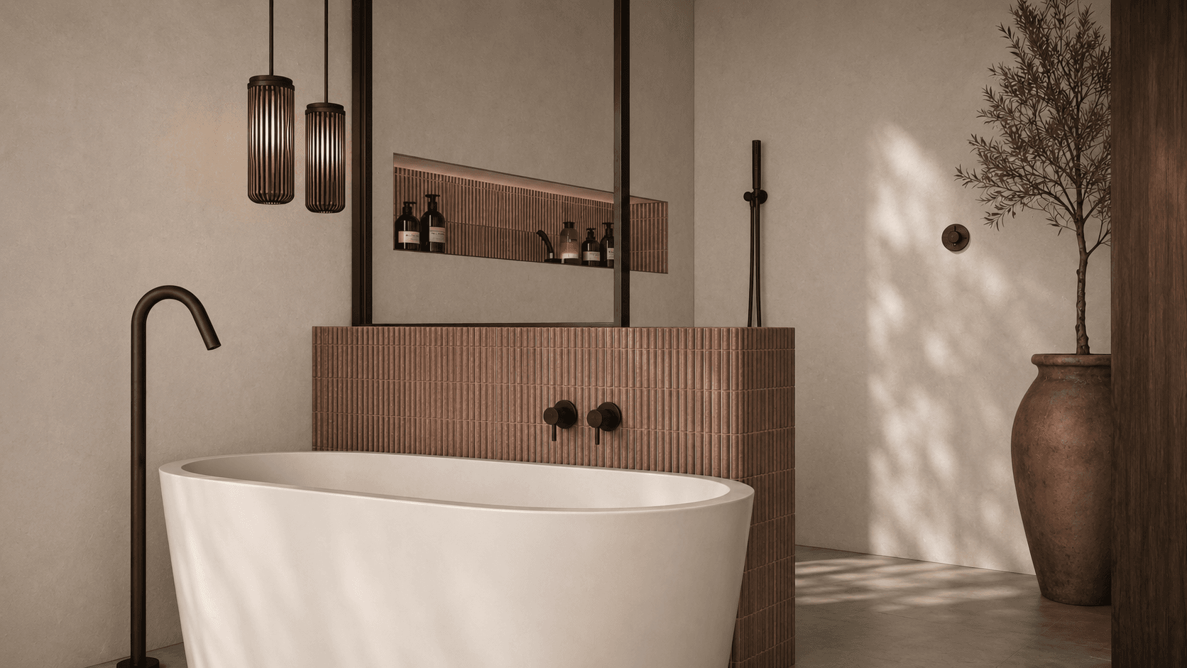 Freestanding bathtub in front of ribbed terracotta tile with bronze floor-mounted tap