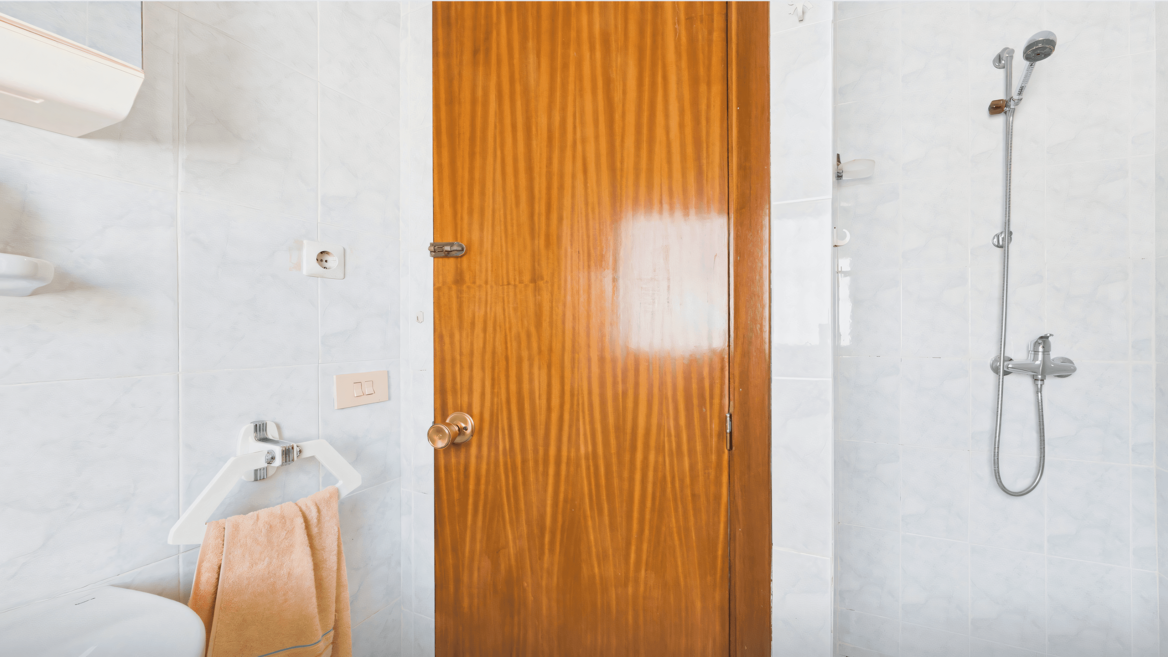 Before: second old bathroom with varnished wood door, shower and hexagonal tiles
