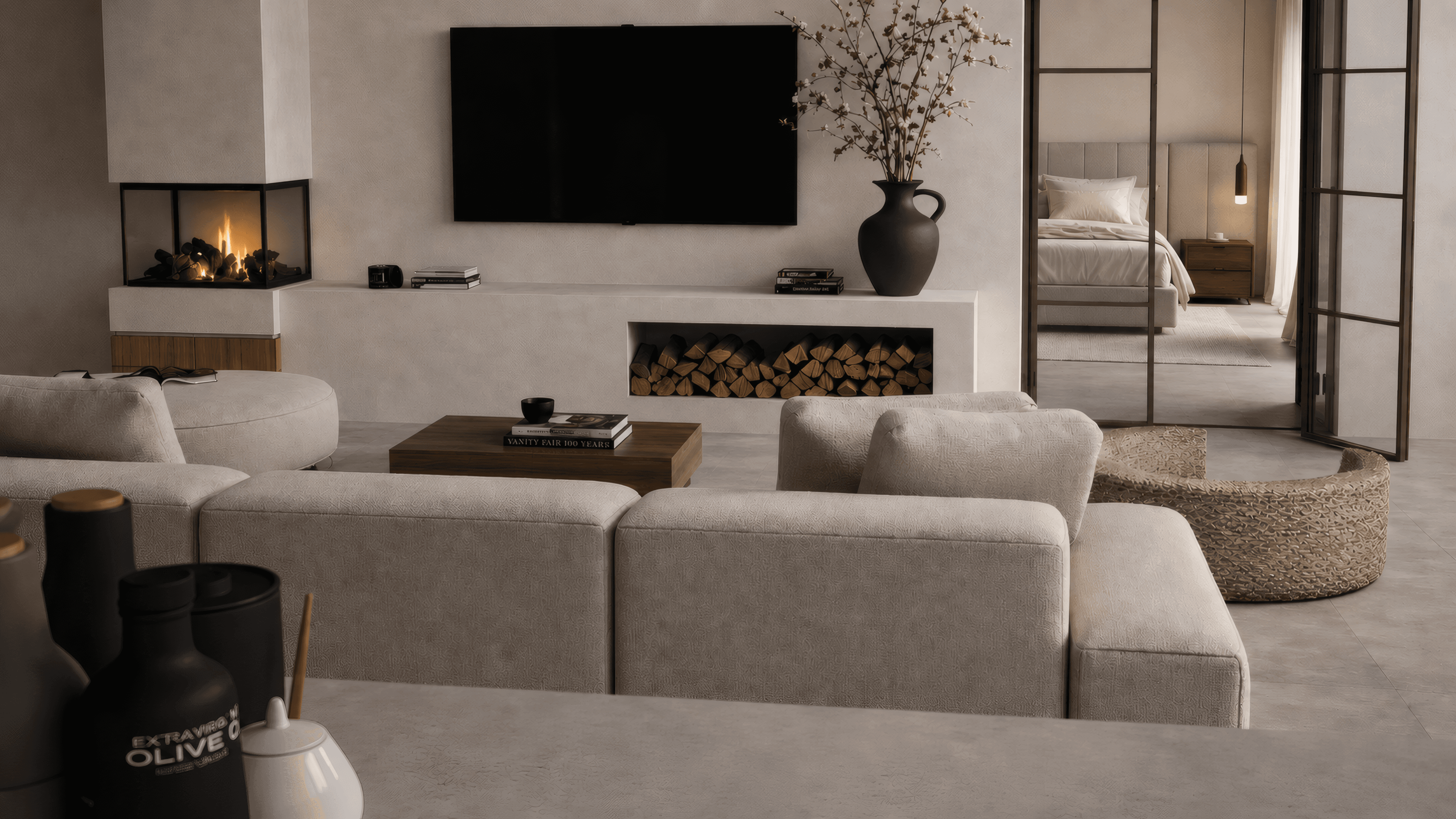 Living room with fireplace, TV wall, cream sofa and a view into a calm bedroom suite