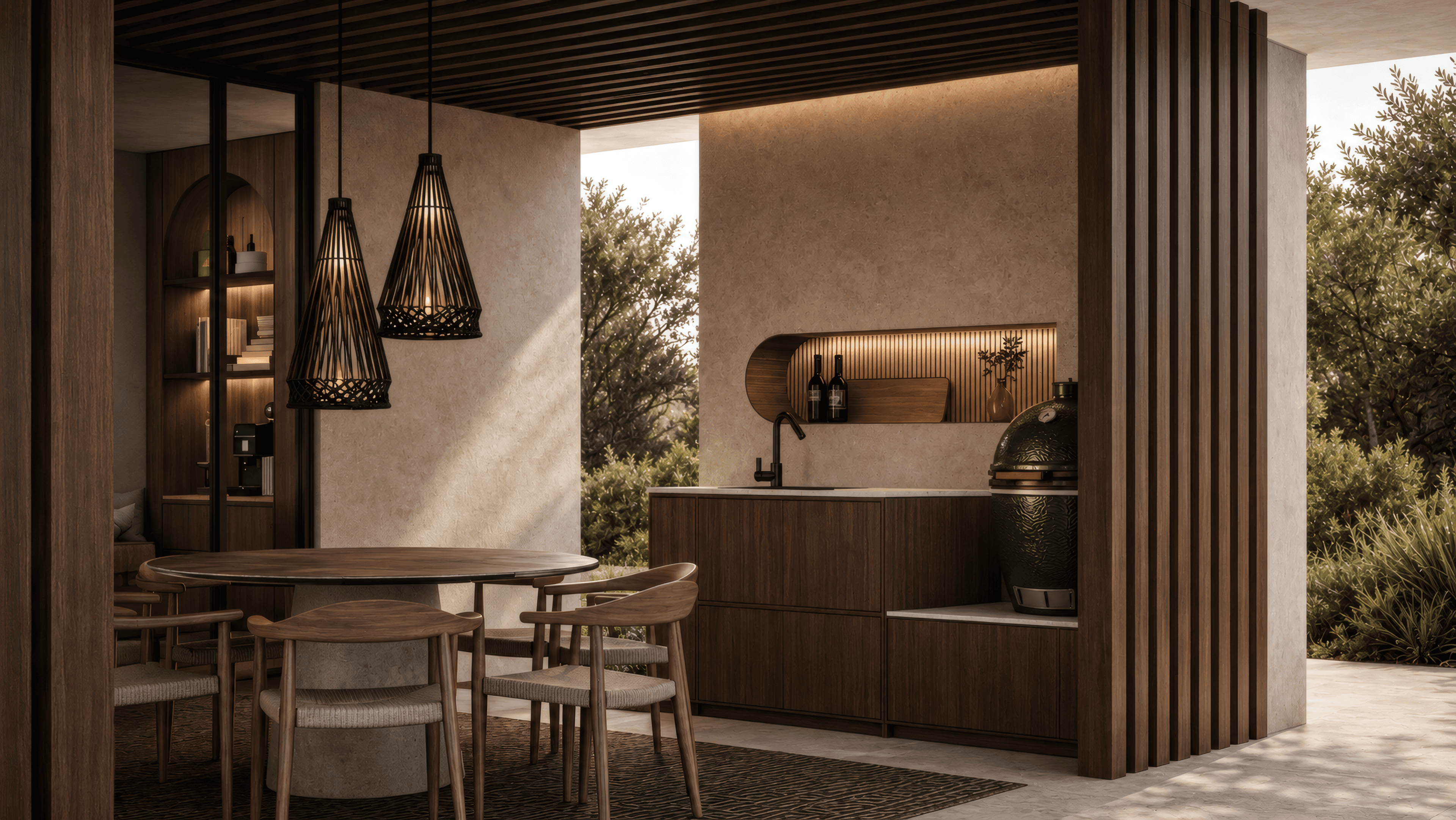 Outdoor kitchen with a light natural stone worktop, dark wood slats and a sculptural recessed shelf in warm evening light