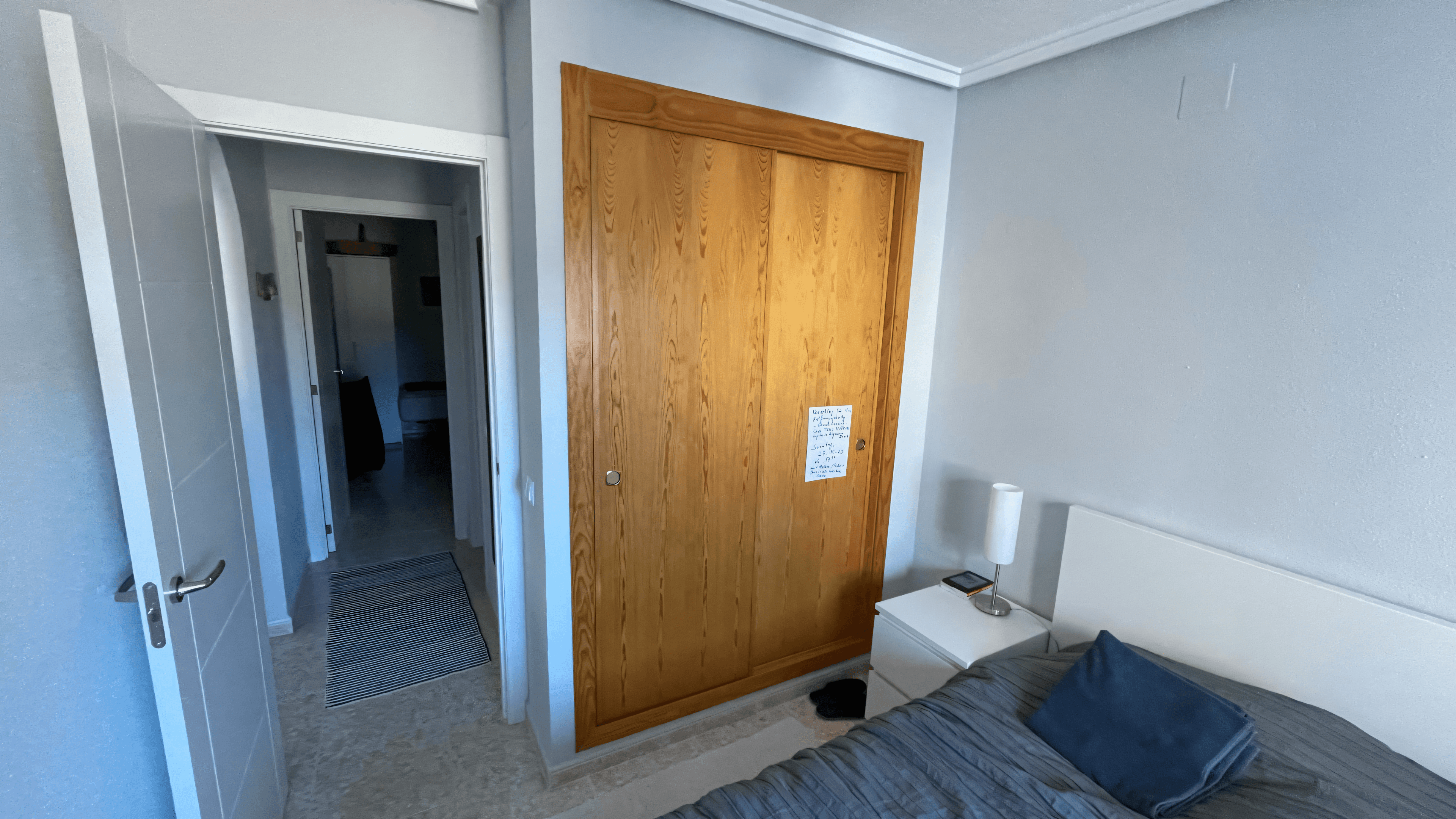 Before: pine sliding door to the wardrobe with grey walls