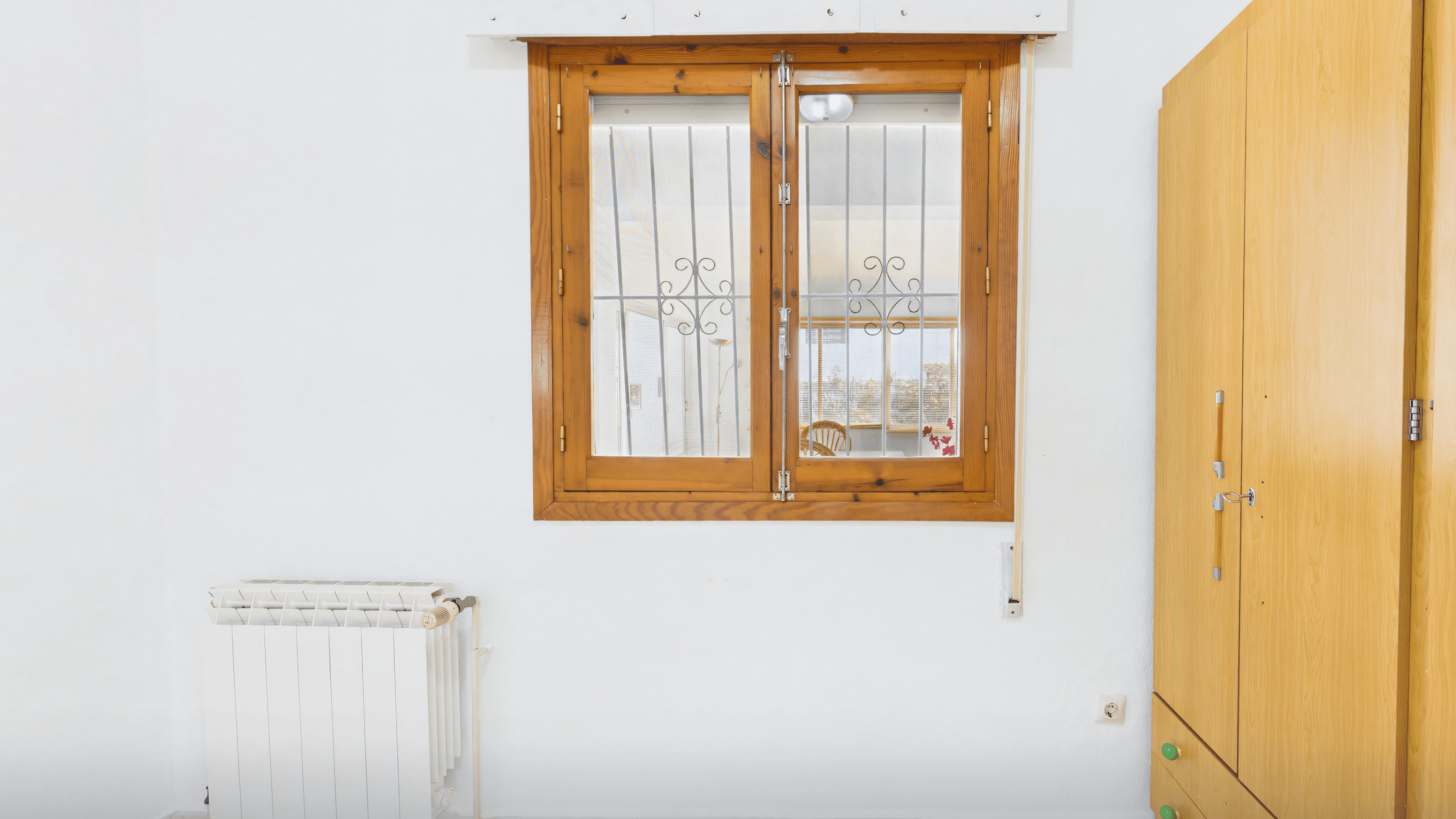 Before: old guest room with pine window and radiator