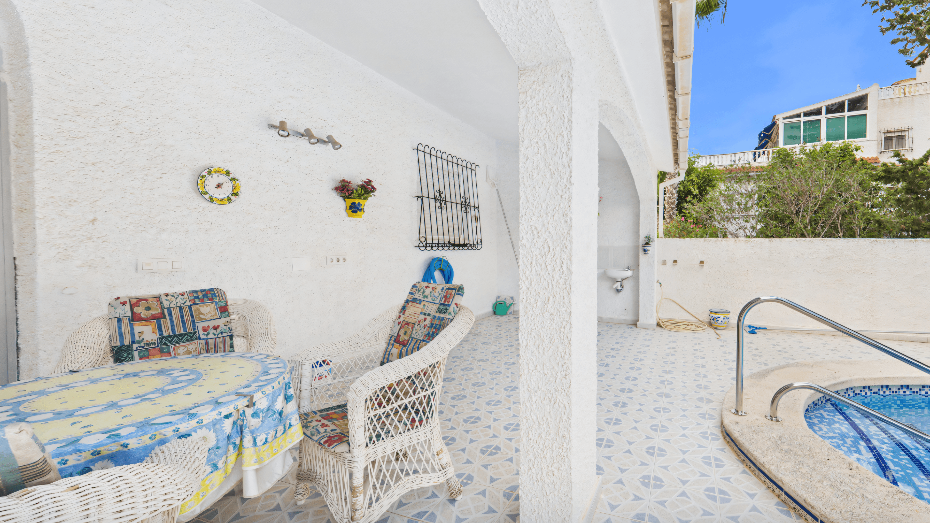 Before: old white covered terrace with ceramic tiles and outdoor sink